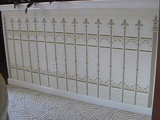 Stenciled art work on half wall in living room